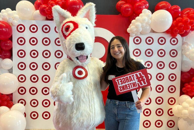 Juliana Iacono poses with the Target mascot, a furry dog